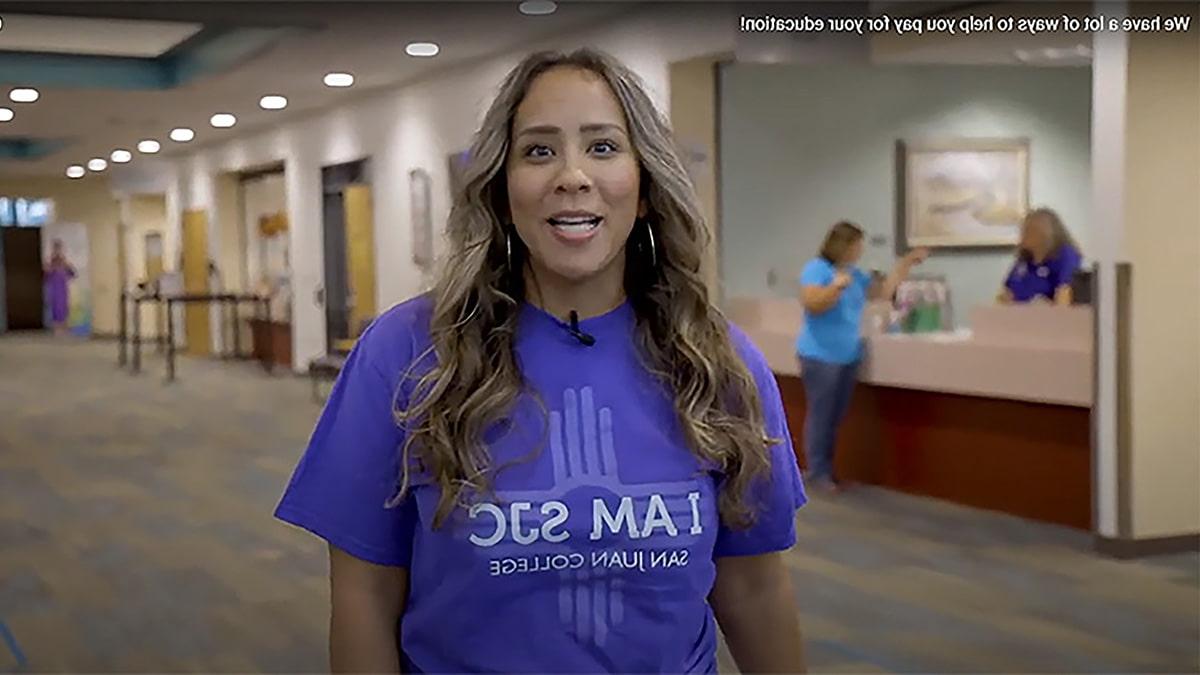 San Juan College student in front of the Financial Aid office